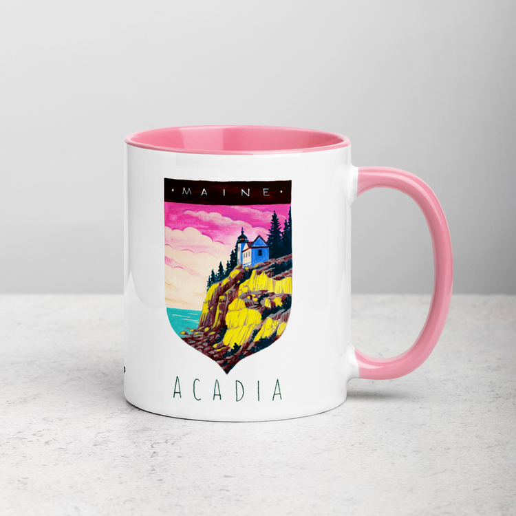 White ceramic coffee mug with pink handle and inside; has Acadia National Park illustration by Angela Staehling