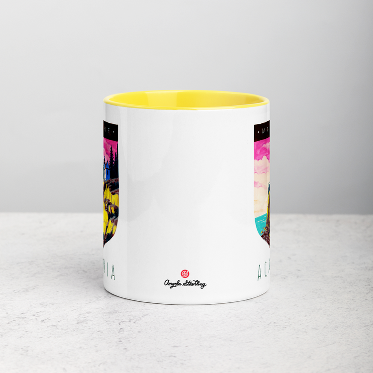 White ceramic coffee mug with yellow handle and inside; has Acadia National Park illustration by Angela Staehling