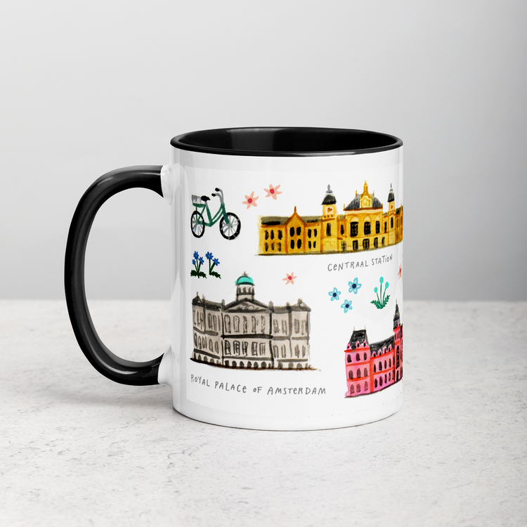 White ceramic coffee mug with black handle and inside; has Amsterdam illustration by Angela Staehling