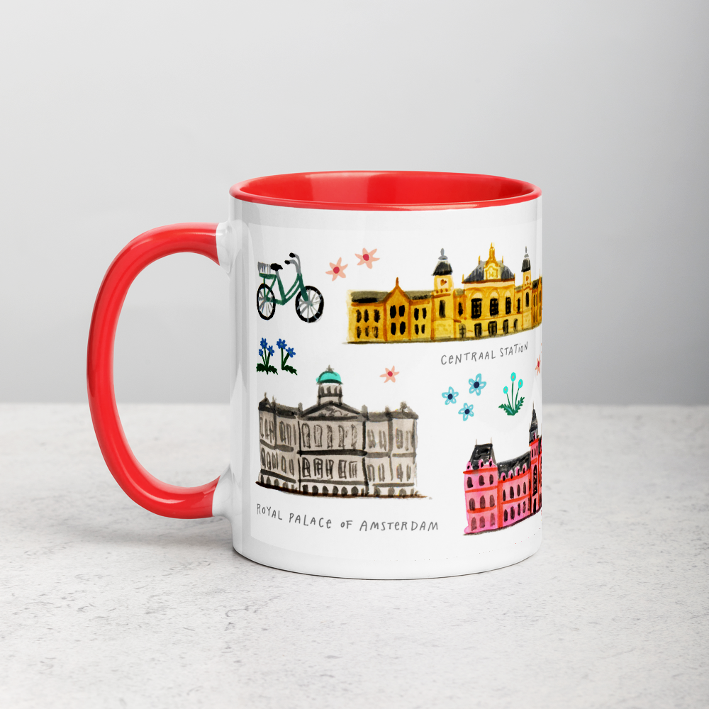 White ceramic coffee mug with orange handle and inside; has Amsterdam illustration by Angela Staehling