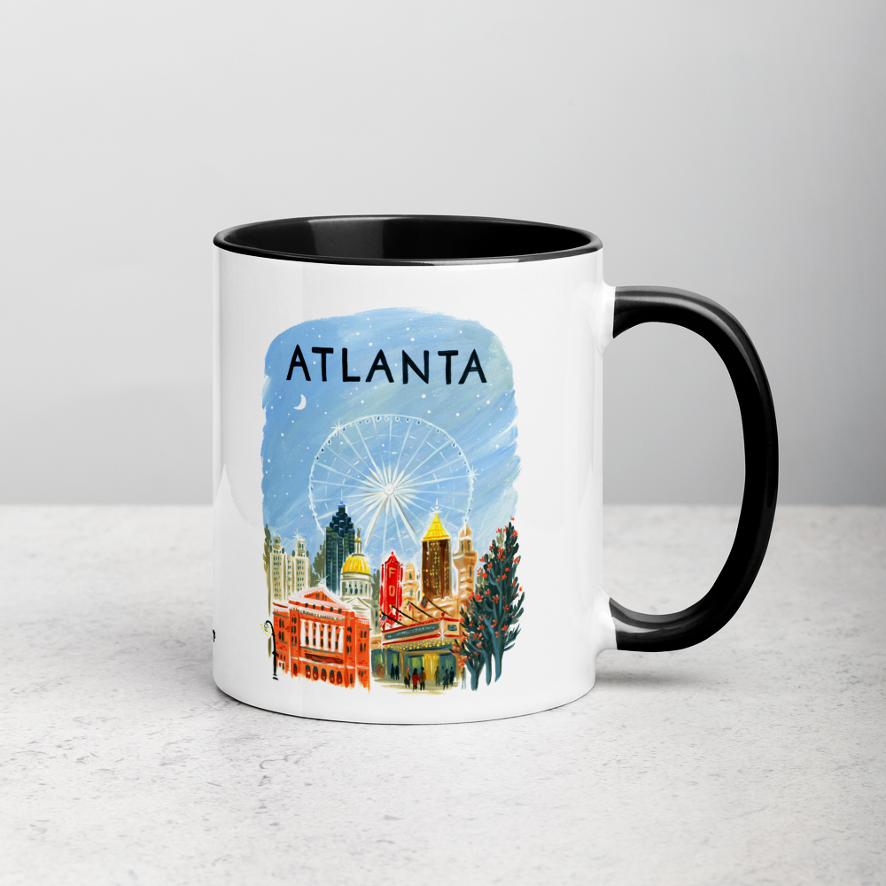 White ceramic coffee mug with black handle and inside; has Atlanta illustration by Angela Staehling
