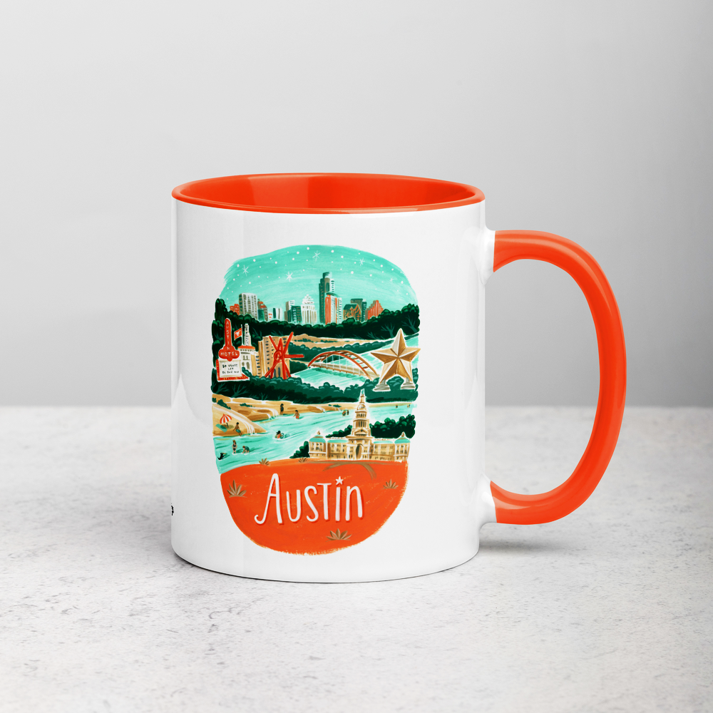 White ceramic coffee mug with orange handle and inside; has Austin illustration by Angela Staehling