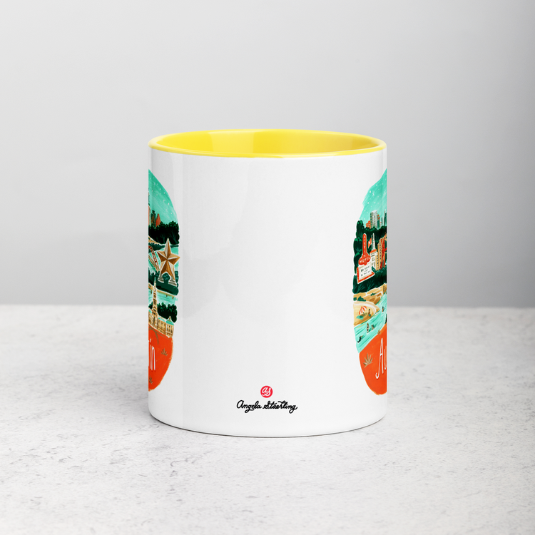 White ceramic coffee mug with yellow handle and inside; has Austin illustration by Angela Staehling