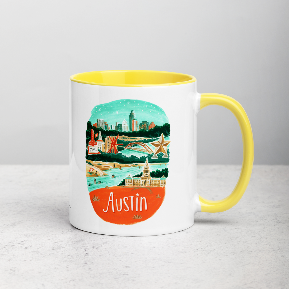 White ceramic coffee mug with yellow handle and inside; has Austin illustration by Angela Staehling