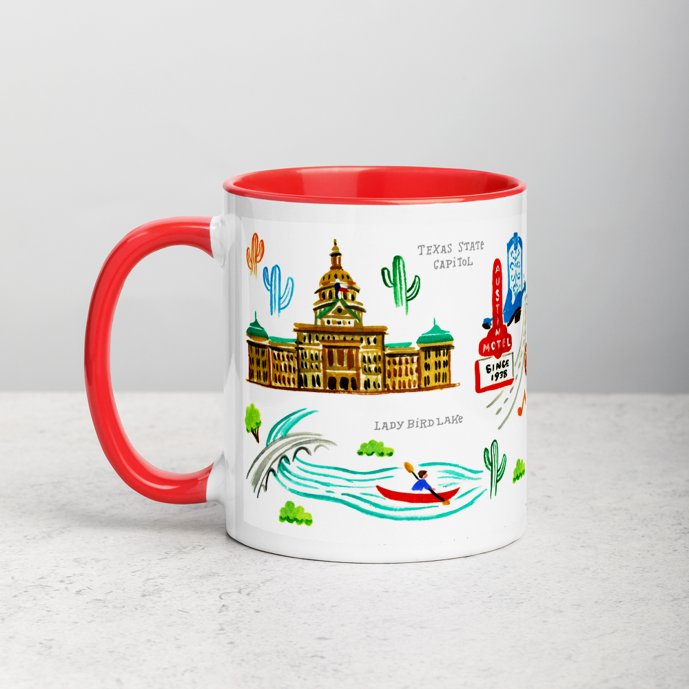 White ceramic coffee mug with red handle and inside; has Austin landmarks illustration by Angela Staehling
