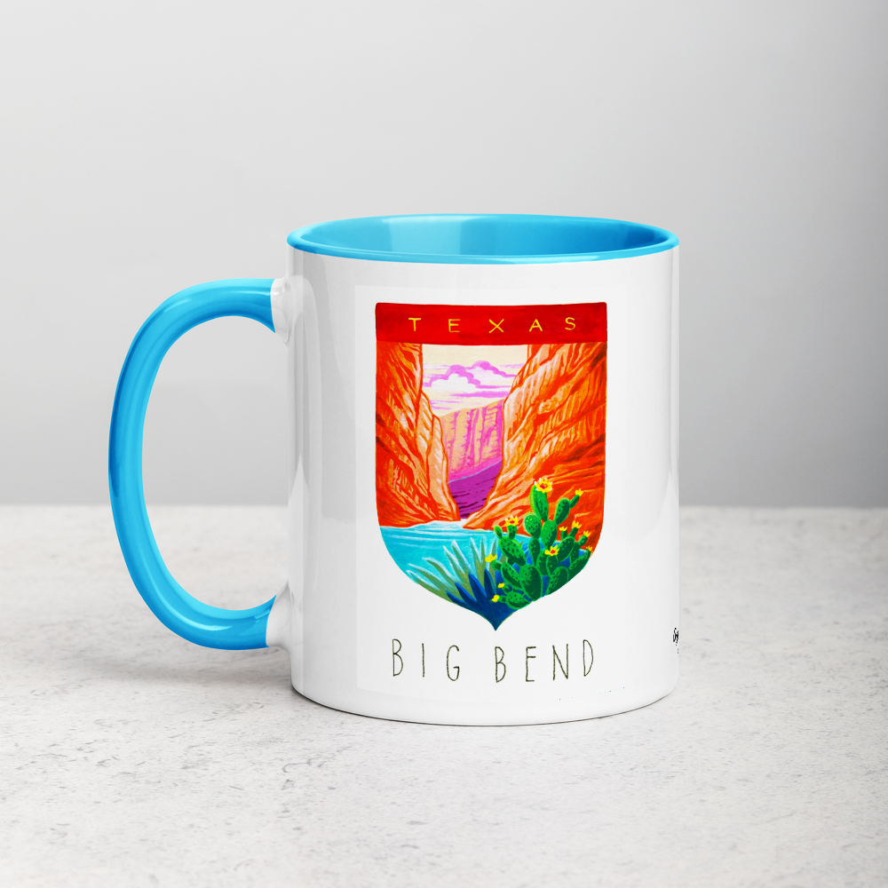 White ceramic coffee mug with blue handle and inside; has Big Bend National Park illustration by Angela Staehling