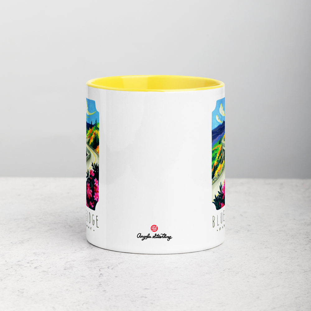 White ceramic coffee mug with yellow handle and inside; has Blue Ridge Parkway National Park illustration by Angela Staehling
