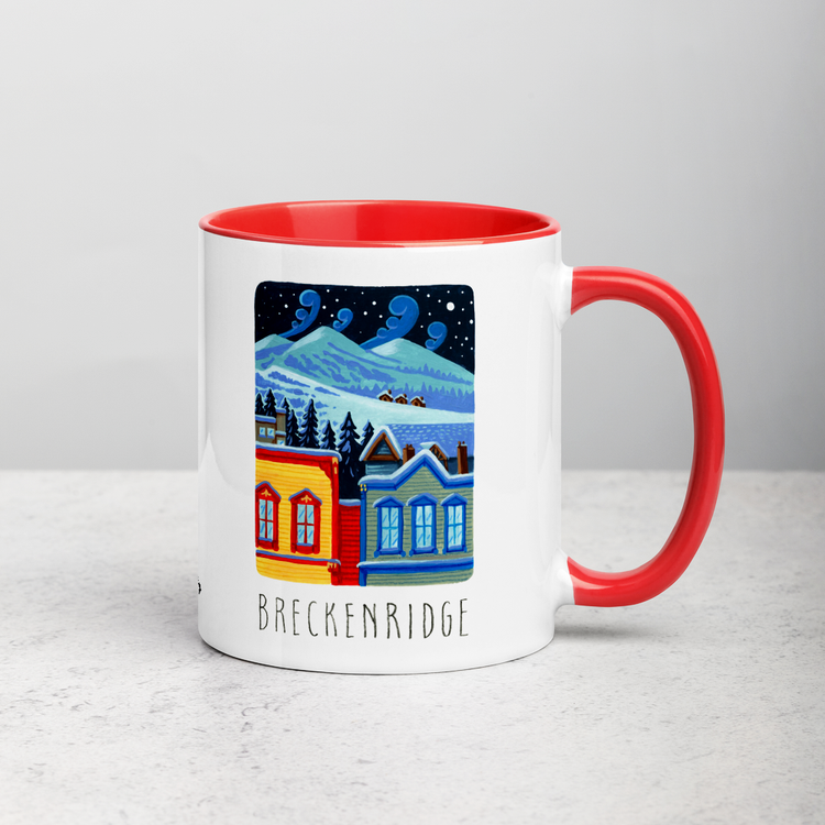 White ceramic coffee mug with red handle and inside; has Breckenridge illustration by Angela Staehling