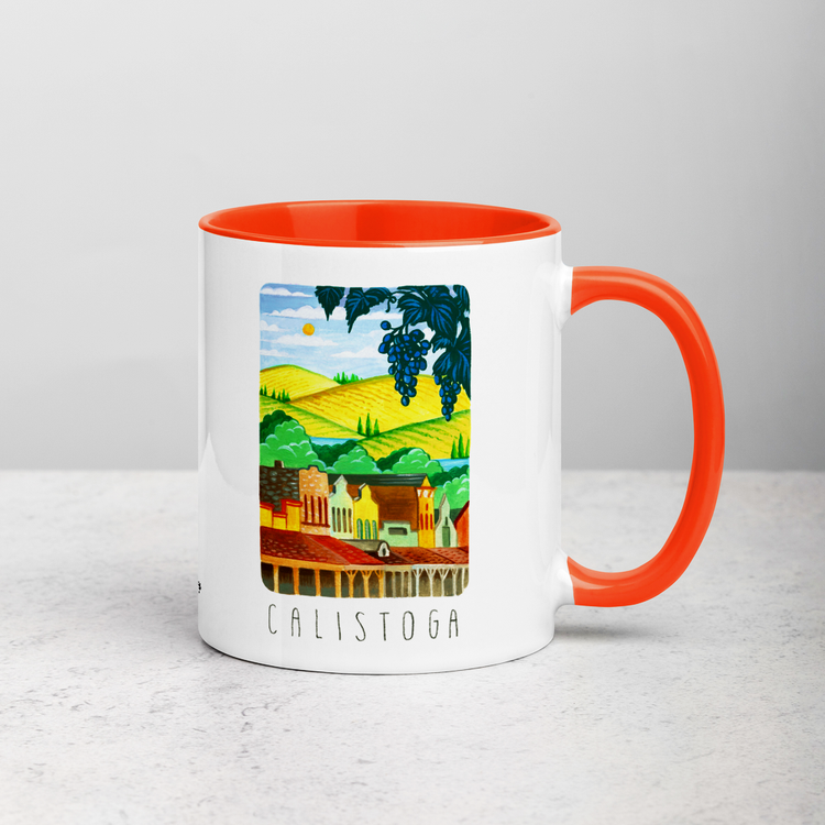 White ceramic coffee mug with orange handle and inside; has Calistoga California illustration by Angela Staehling