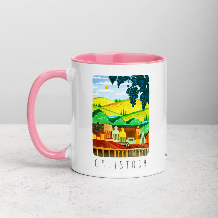 White ceramic coffee mug with pink handle and inside; has Calistoga California illustration by Angela Staehling