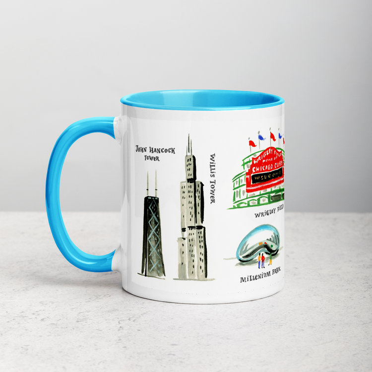 White ceramic coffee mug with blue handle and inside; has Chicago landmarks illustration by Angela Staehling