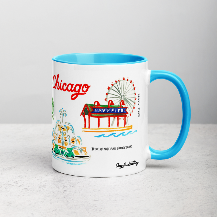 White ceramic coffee mug with blue handle and inside; has Chicago landmarks illustration by Angela Staehling