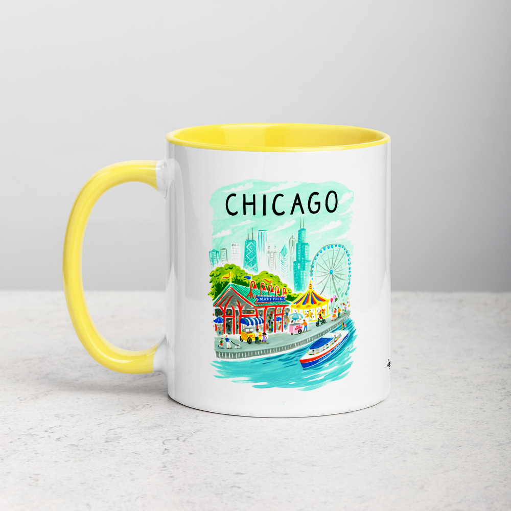 White ceramic coffee mug with orange handle and inside; has Chicago Navy Pier illustration by Angela Staehling