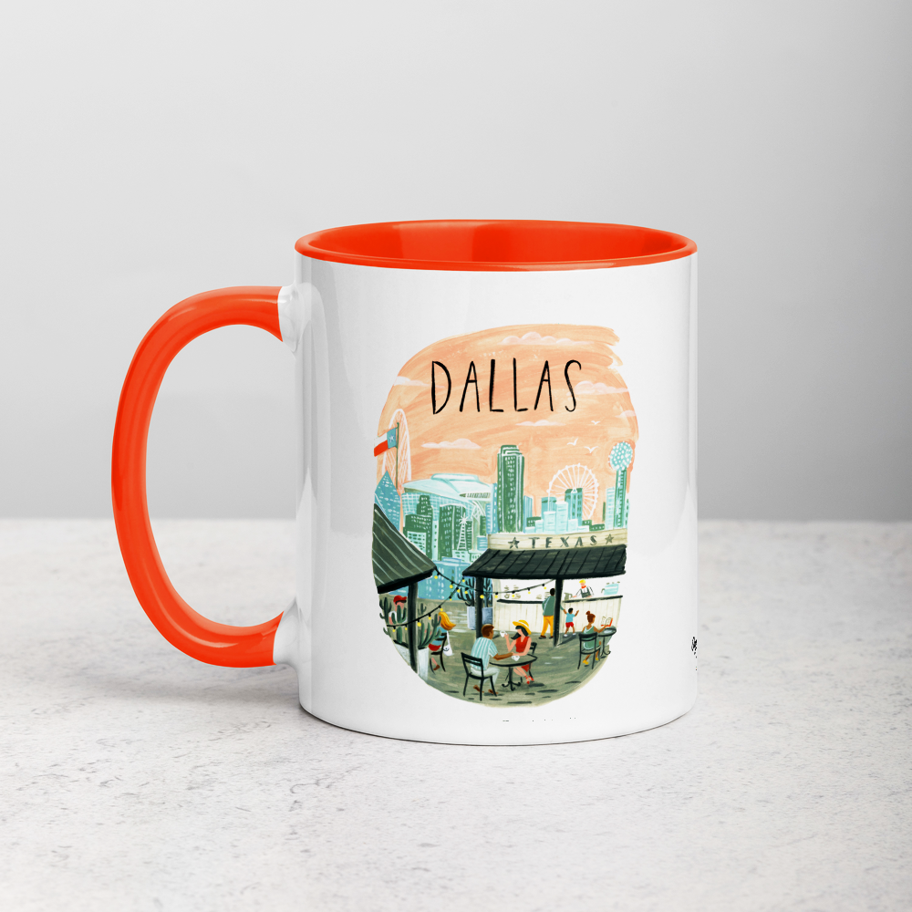 White ceramic coffee mug with orange handle and inside; has Dallas Texas illustration by Angela Staehling