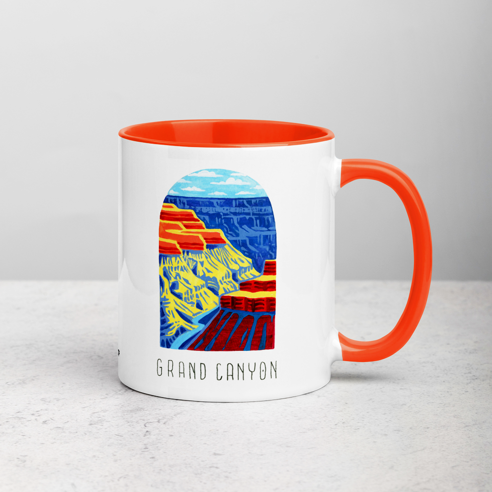 White ceramic coffee mug with orange handle and inside; has Grand Canyon National Park illustration by Angela Staehling