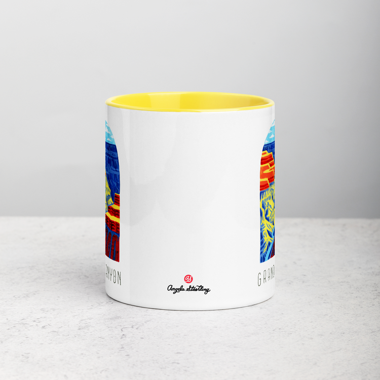 White ceramic coffee mug with yellow handle and inside; has Grand Canyon National Park illustration by Angela Staehling