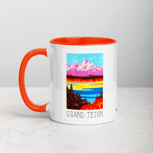 White ceramic coffee mug with orange handle and inside; has Grand Teton National Park illustration by Angela Staehling