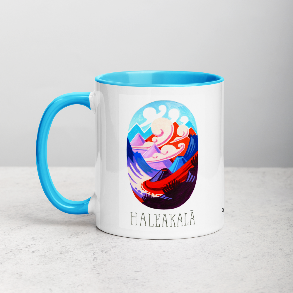 White ceramic coffee mug with blue handle and inside; has Haleakala National Park illustration by Angela Staehling