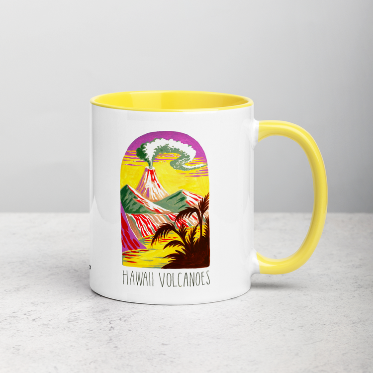 White ceramic coffee mug with yellow handle and inside; has Hawaii Volcanoes National Park illustration by Angela Staehling