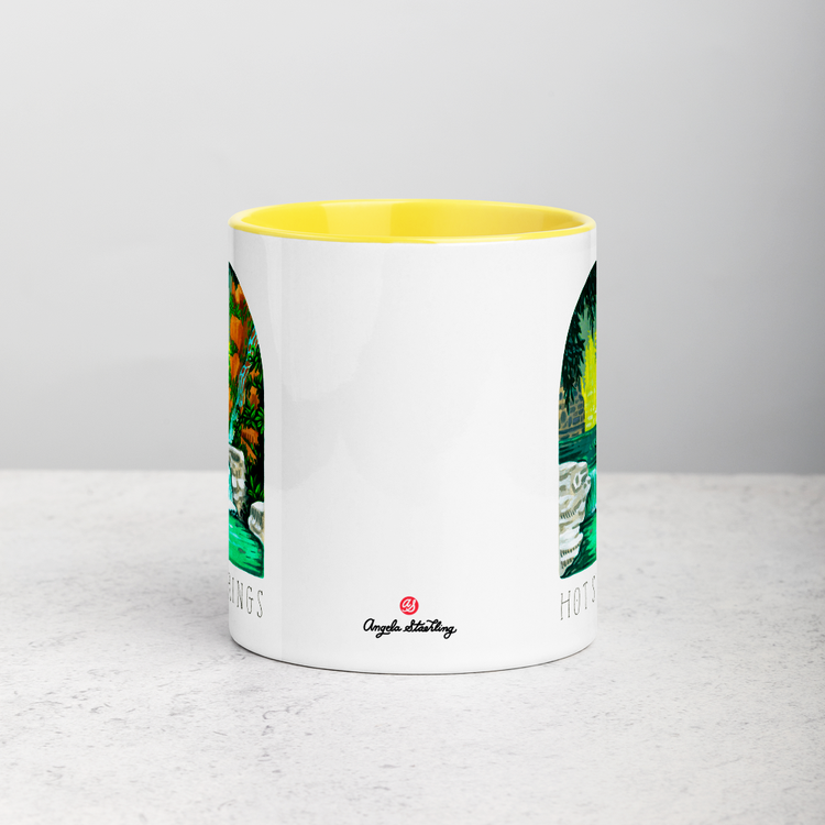 White ceramic coffee mug with yellow handle and inside; has Hot Springs National Park illustration by Angela Staehling
