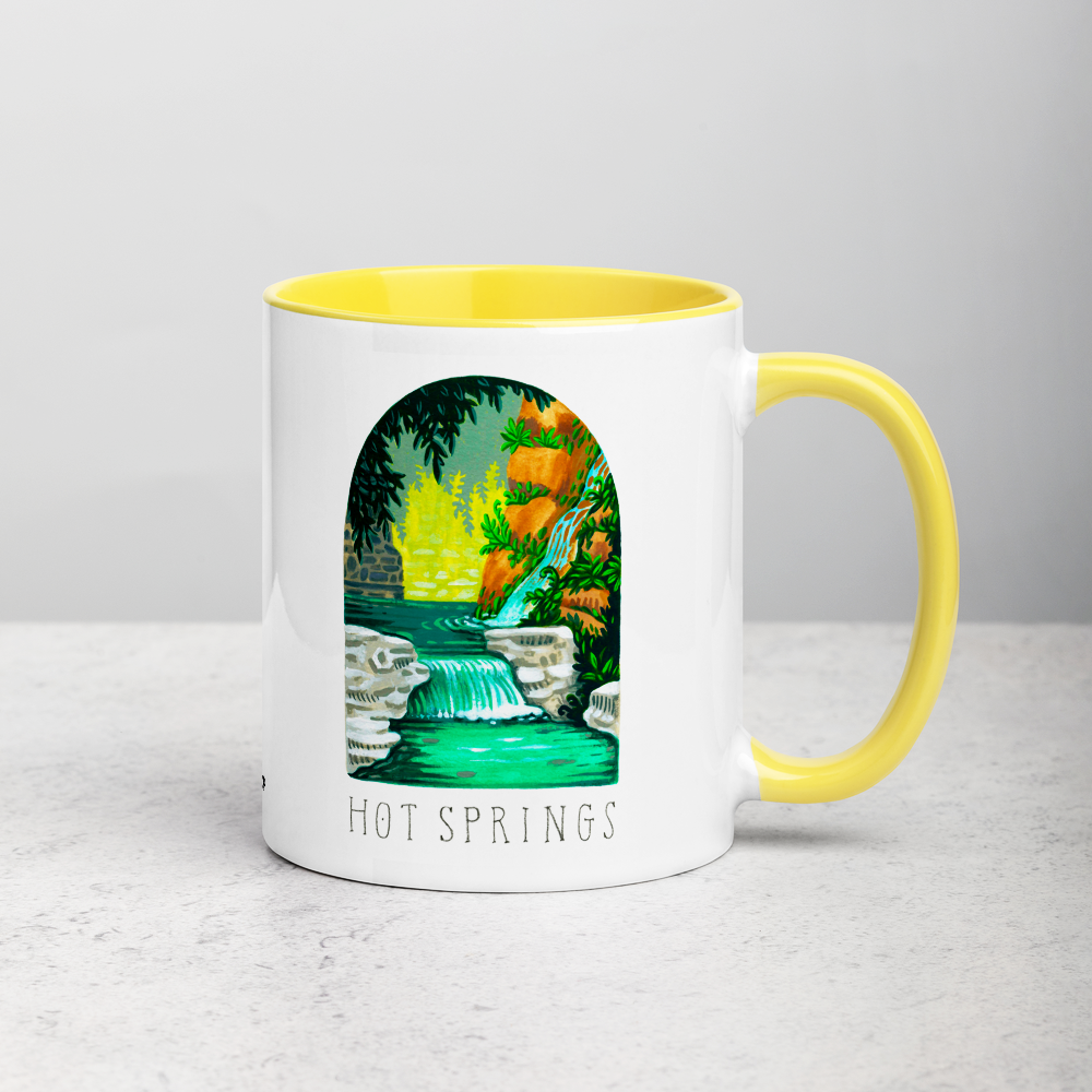 White ceramic coffee mug with yellow handle and inside; has Hot Springs National Park illustration by Angela Staehling