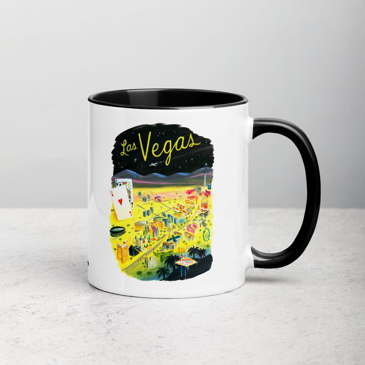 White ceramic coffee mug with black handle and inside; has Las Vegas illustration by Angela Staehling
