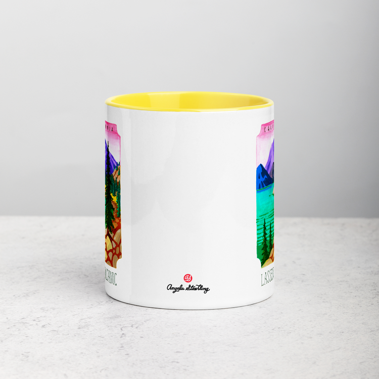 White ceramic coffee mug with yellow handle and inside; has Lassen Volcanic National Park illustration by Angela Staehling