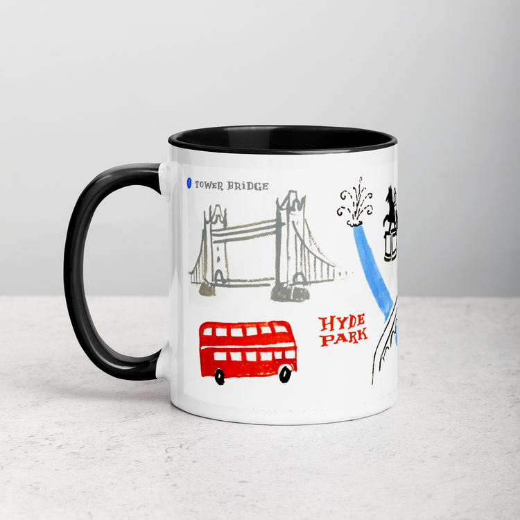 White ceramic coffee mug with black handle and inside; has London landmarks illustration by Angela Staehling