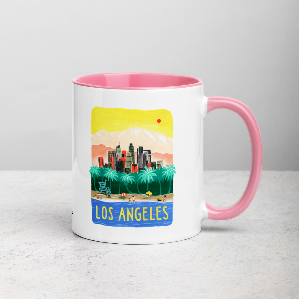 White ceramic coffee mug with pink handle and inside; has Los Angeles California illustration by Angela Staehling