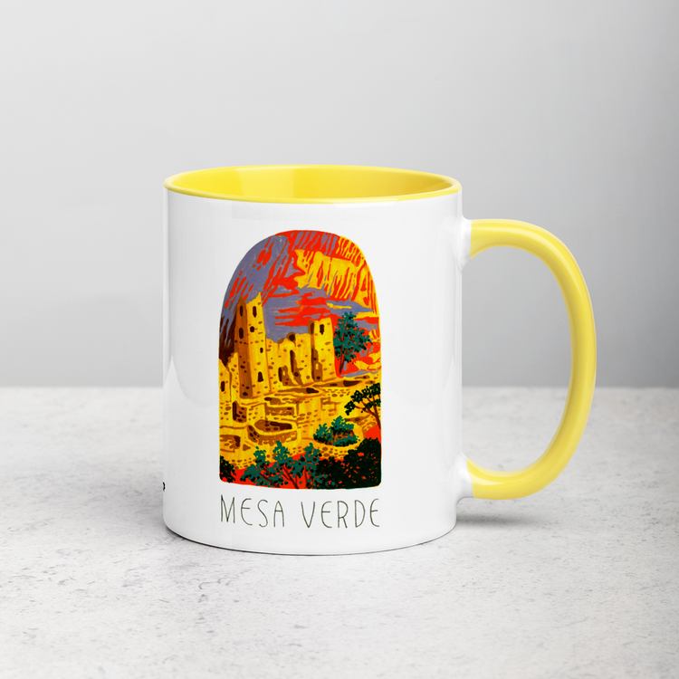 White ceramic coffee mug with yellow handle and inside; has Mesa Verde National Park illustration by Angela Staehling