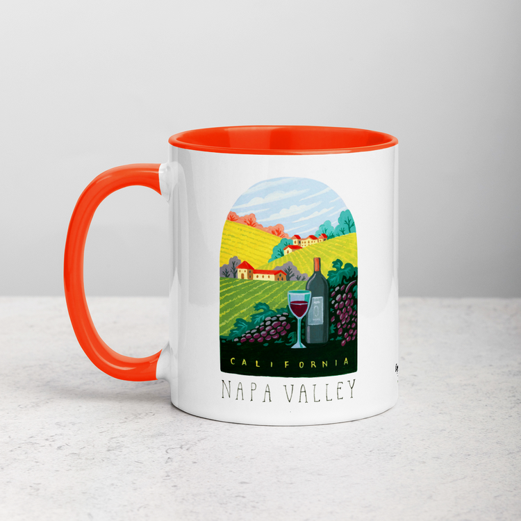 White ceramic coffee mug with orange handle and inside; has Napa Valley California illustration by Angela Staehling