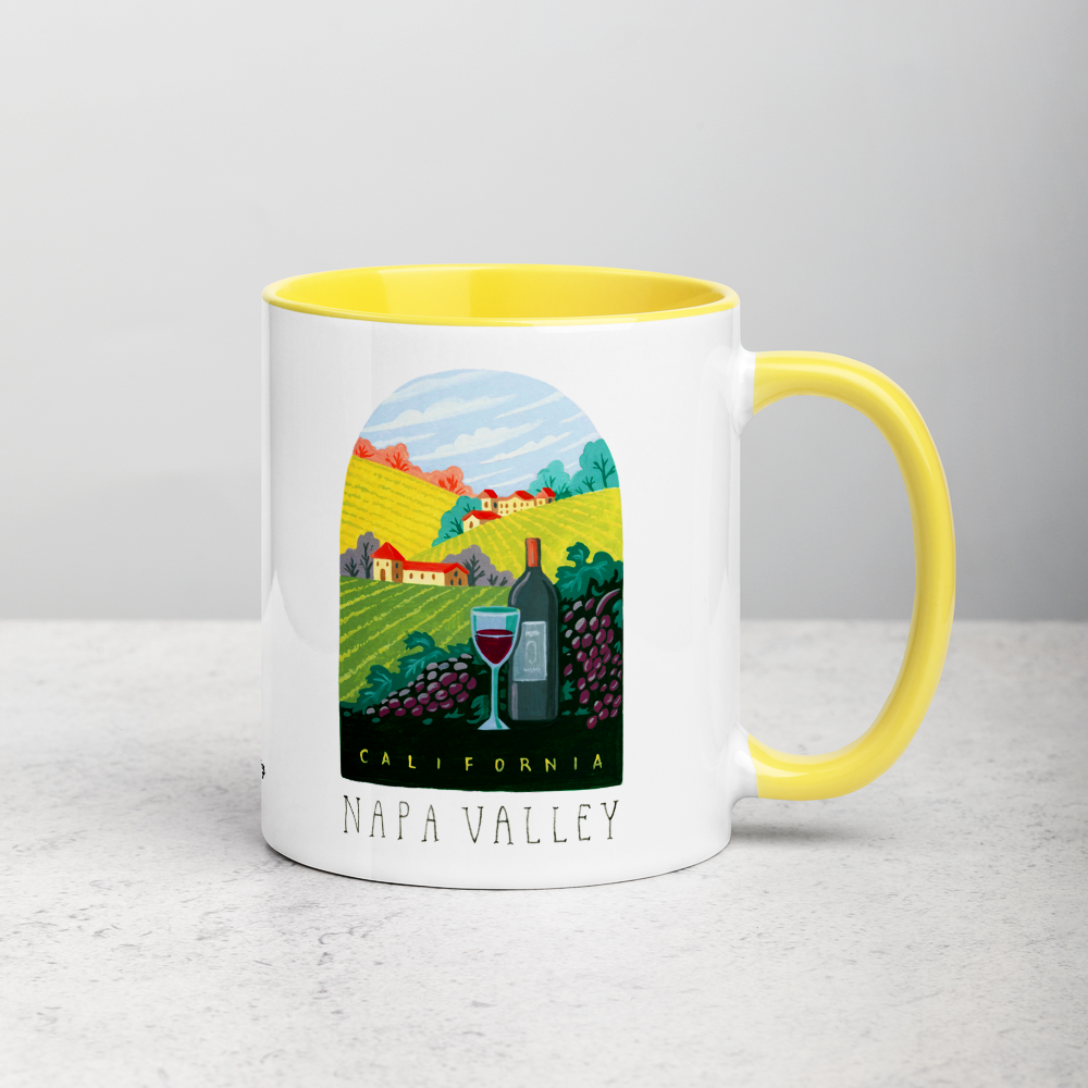 White ceramic coffee mug with yellow handle and inside; has Napa Valley California illustration by Angela Staehling