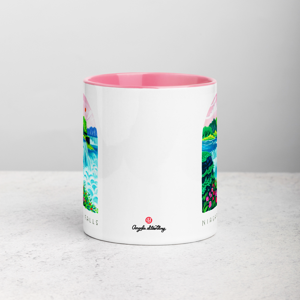 White ceramic coffee mug with pink handle and inside; has Niagara Falls National Park illustration by Angela Staehling