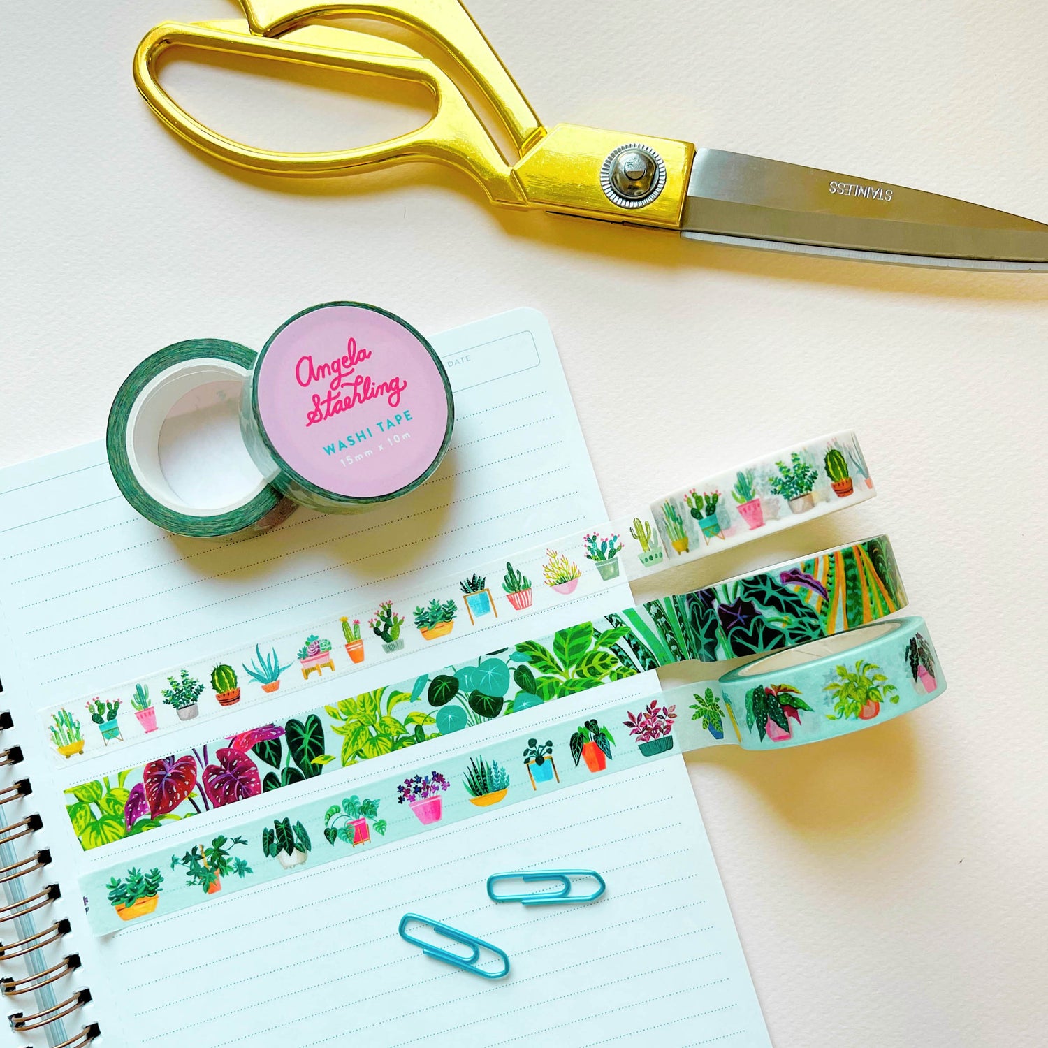 Three rolls of plant washi tape with scissors and paper clips