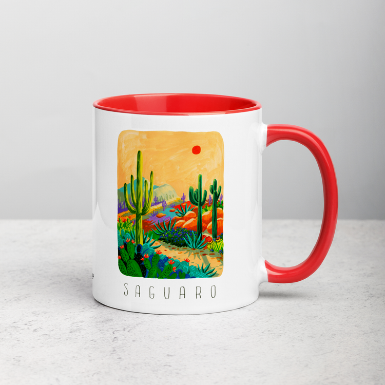 White ceramic coffee mug with red handle and inside; has Saguaro National Park illustration by Angela Staehling