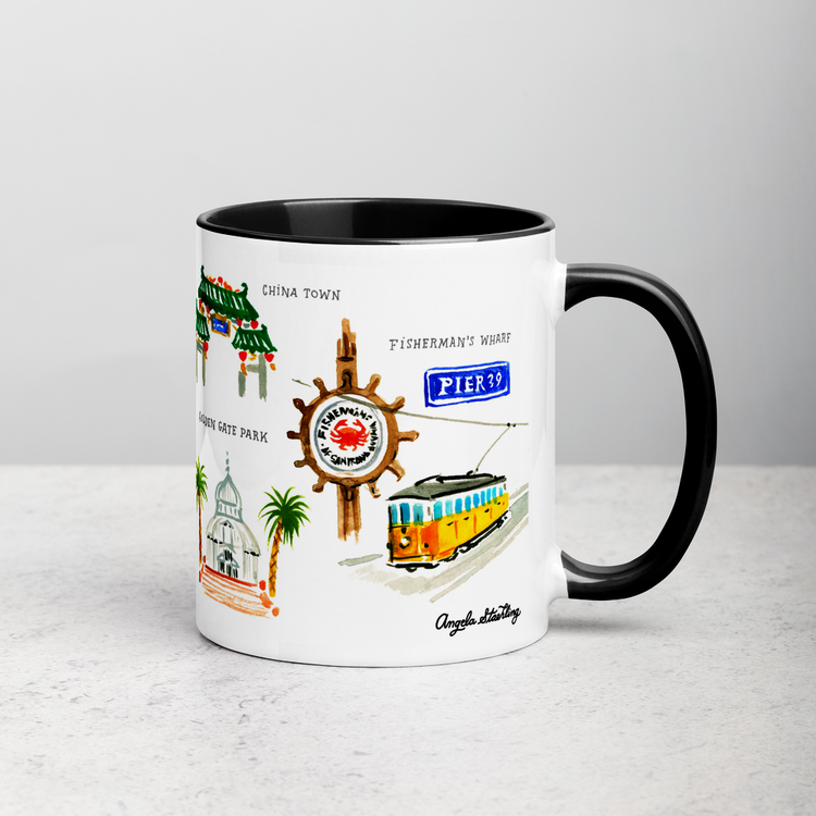 White ceramic coffee mug with black handle and inside; has San Francisco landmarks illustration by Angela Staehling