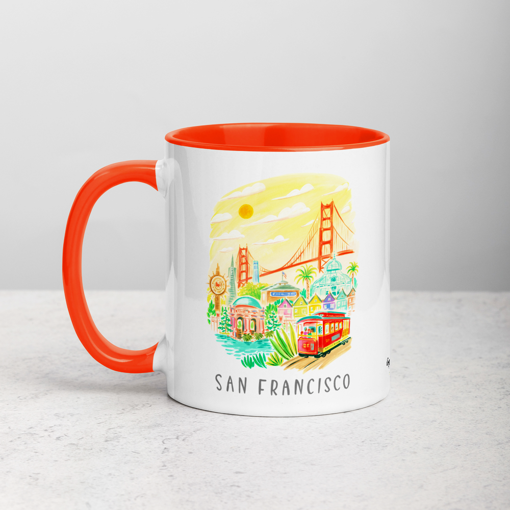 White ceramic coffee mug with orange handle and inside; has San Francisco Golden Gate illustration by Angela Staehling