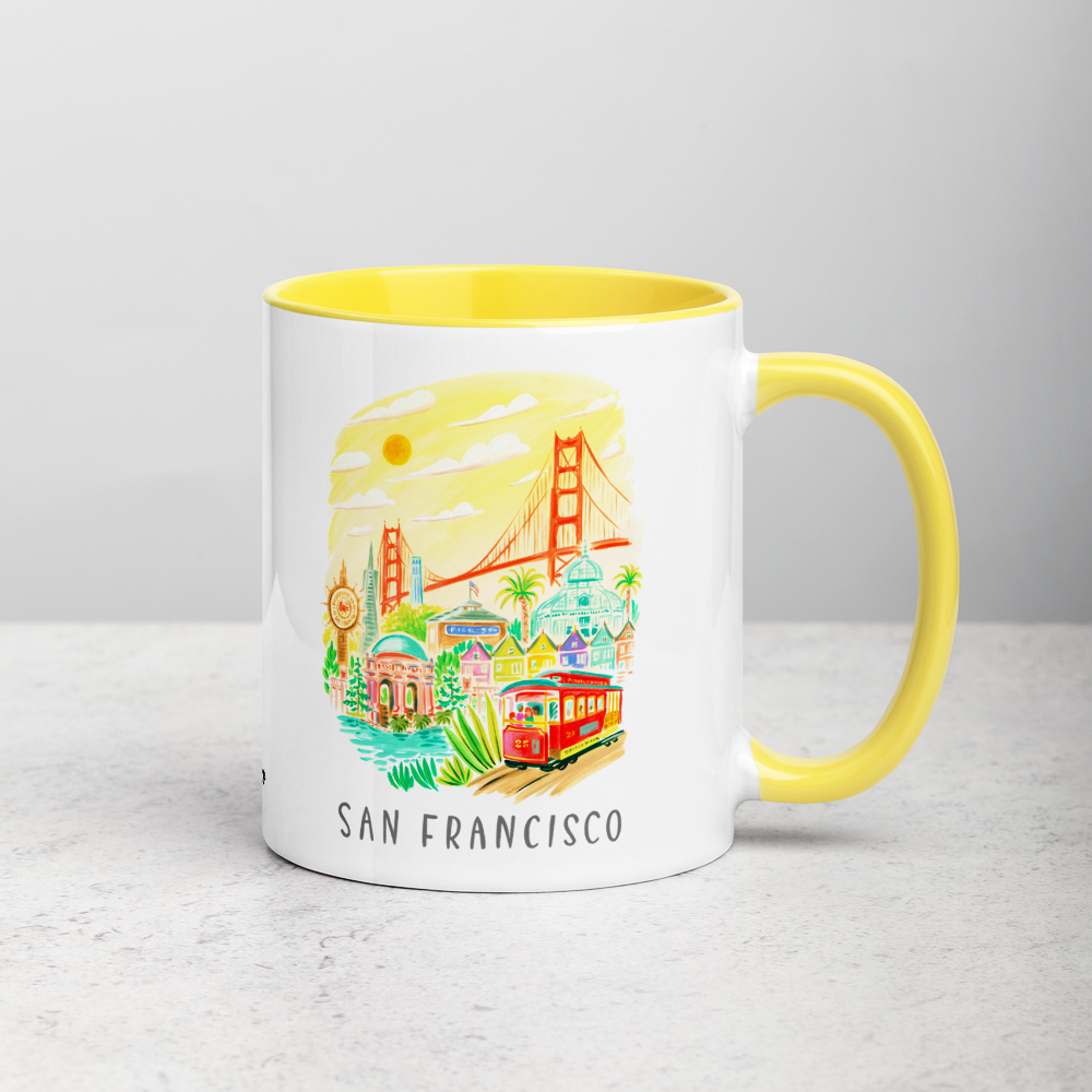White ceramic coffee mug with yellow handle and inside; has San Francisco Golden Gate illustration by Angela Staehling