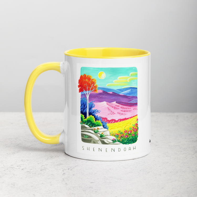 White ceramic coffee mug with yellow handle and inside; has Shenandoah National Park illustration by Angela Staehling