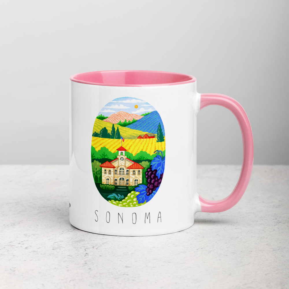 White ceramic coffee mug with pink handle and inside; has Sonoma Valley California illustration by Angela Staehling