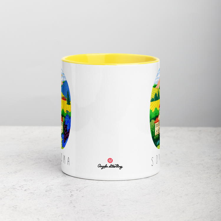 White ceramic coffee mug with yellow handle and inside; has Sonoma Valley California illustration by Angela Staehling