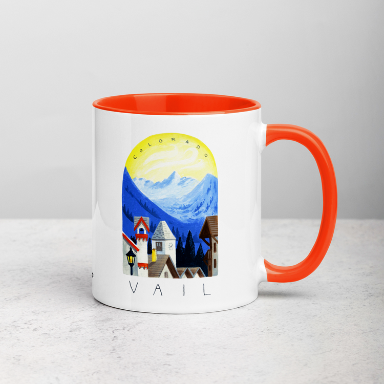 White ceramic coffee mug with orange handle and inside; has Sonoma Vail Colorado illustration by Angela Staehling