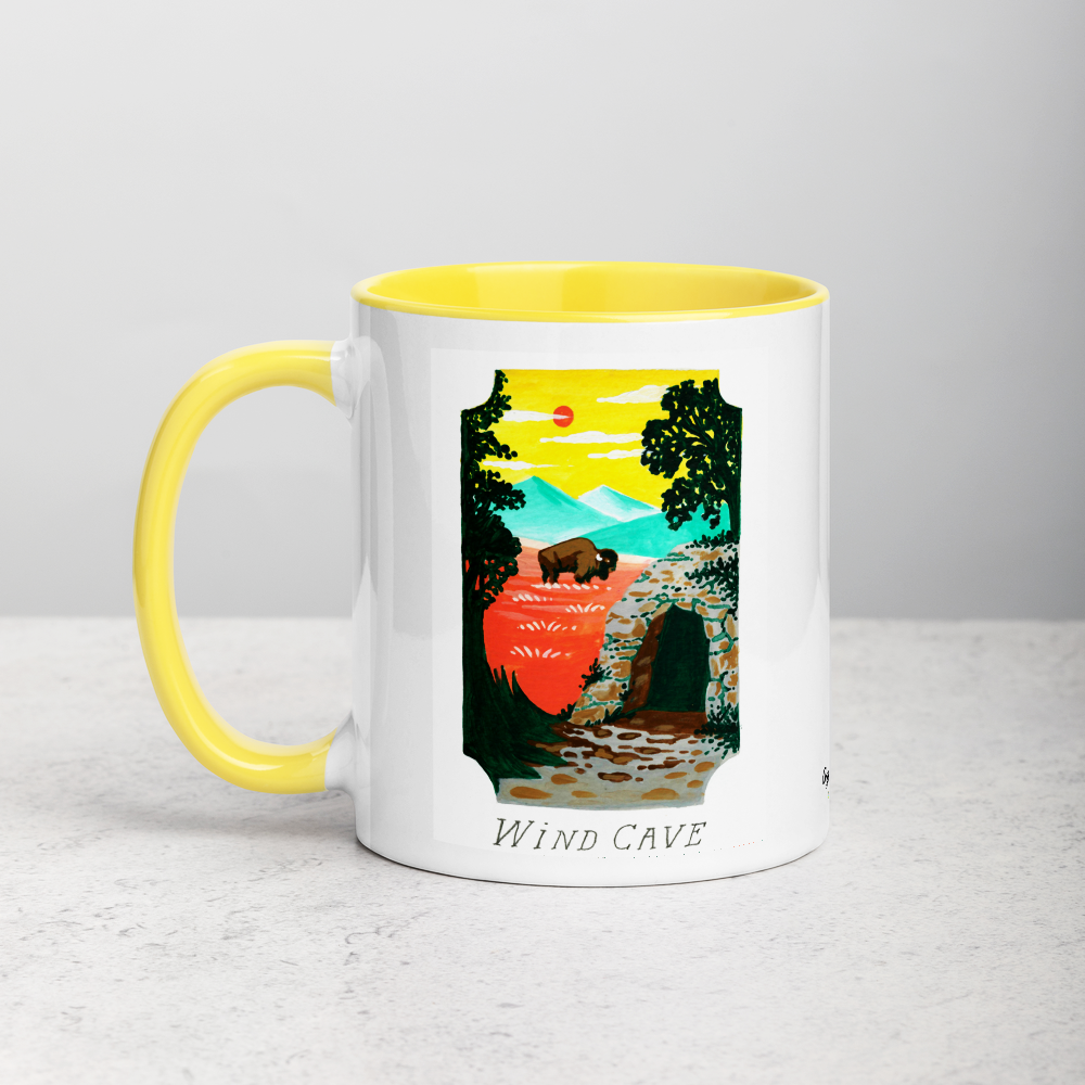 White ceramic coffee mug with yellow handle and inside; has Wind Cave National Park illustration by Angela Staehling