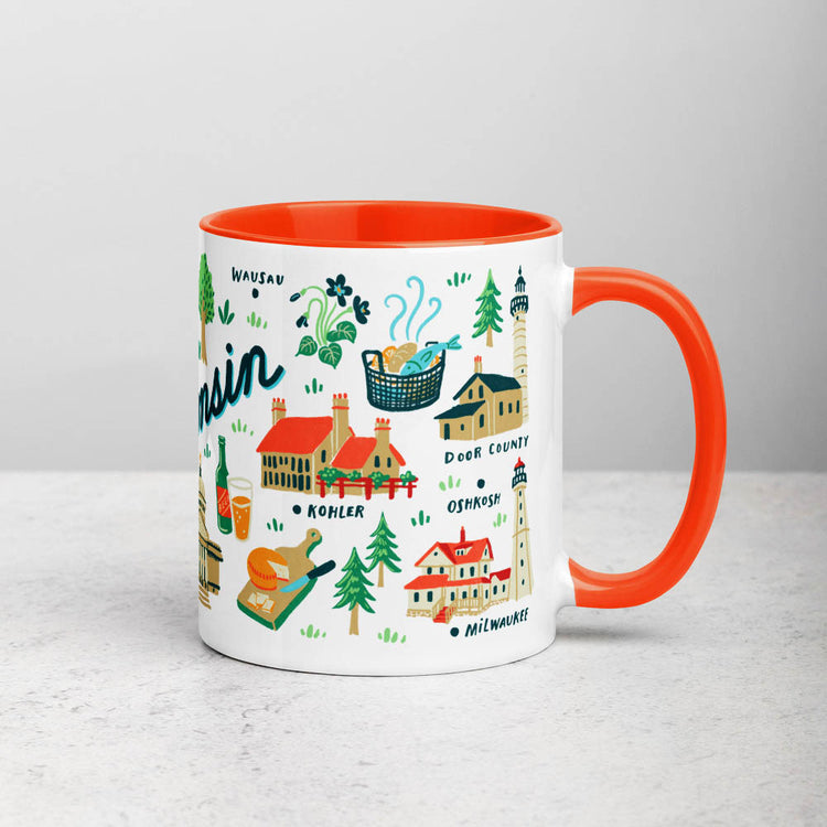White ceramic coffee mug with orange handle and inside; has Wisconsin illustration by Angela Staehling