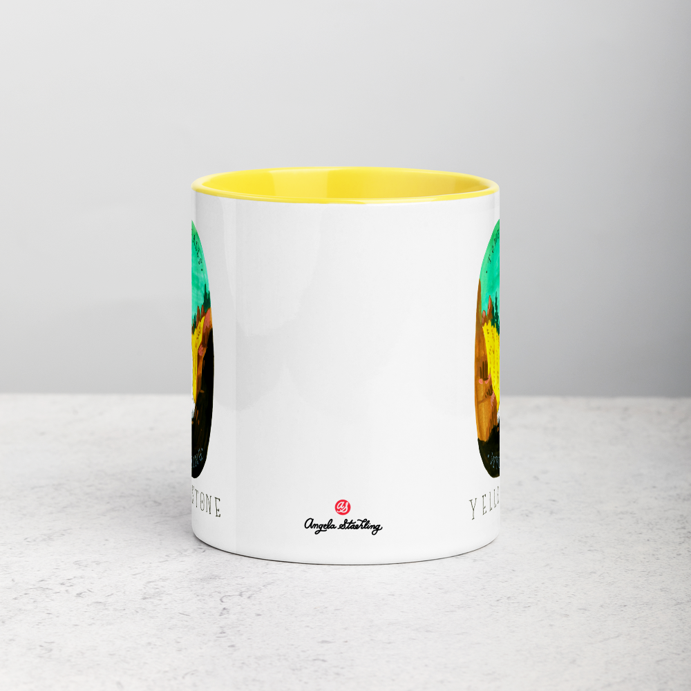 White ceramic coffee mug with yellow handle and inside; has Yellowstone National Park illustration by Angela Staehling