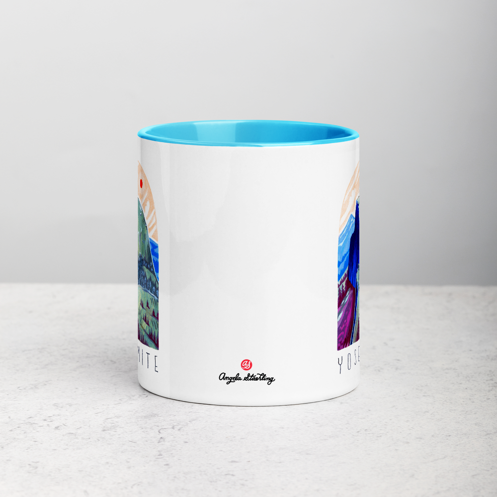 White ceramic coffee mug with blue handle and inside; has Yosemite National Park illustration by Angela Staehling
