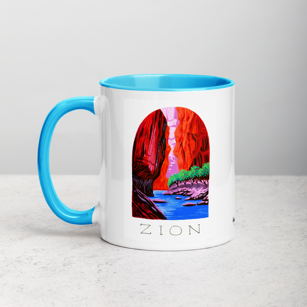 White ceramic coffee mug with blue handle and inside; has Zion National Park illustration by Angela Staehling