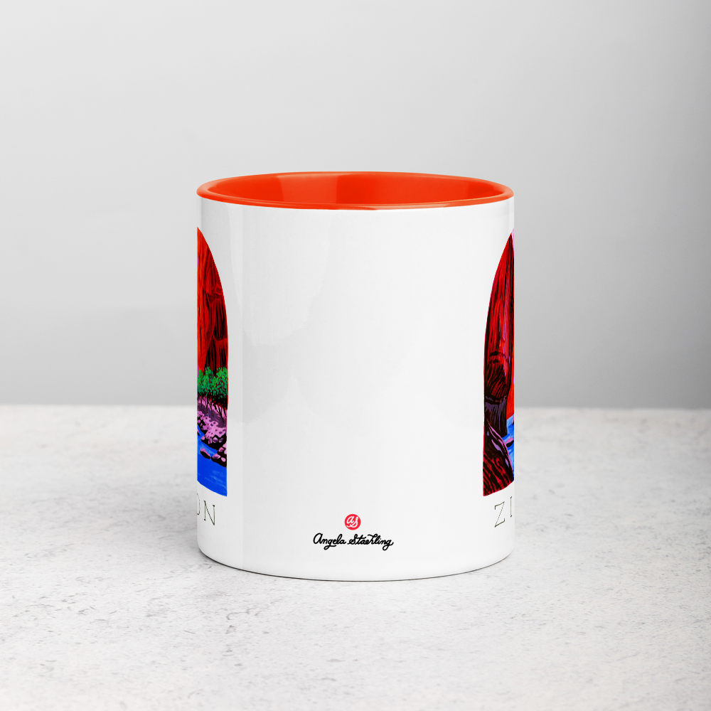 White ceramic coffee mug with orange handle and inside; has Zion National Park illustration by Angela Staehling