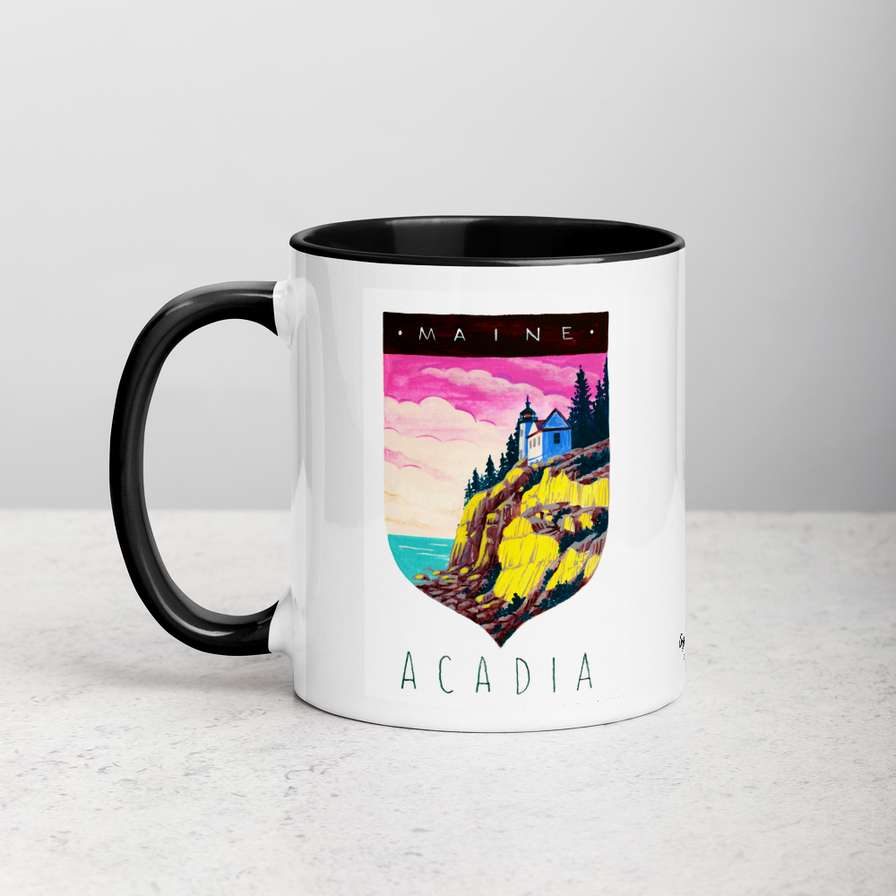 White ceramic coffee mug with black handle and inside; has Acadia National Park illustration by Angela Staehling