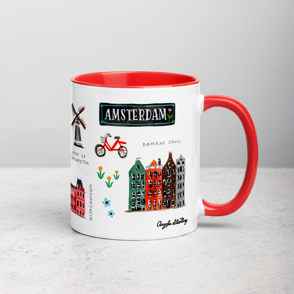 White ceramic coffee mug with orange handle and inside; has Amsterdam illustration by Angela Staehling
